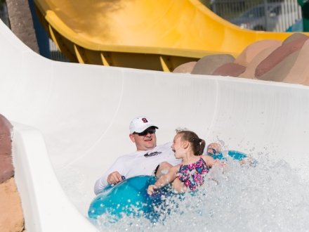 Visitors riding down a water slide at Waterville USA.
