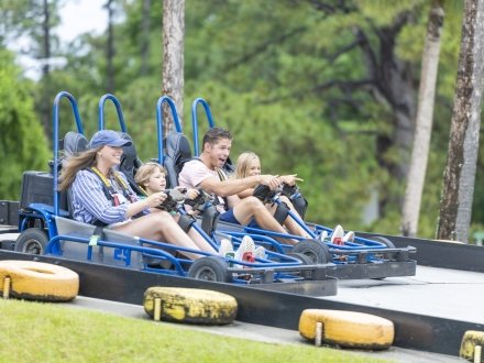 Family racing go-karts at The Track attraction in Gulf Shores
