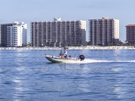 Boat cruising near shore in Orange Beach