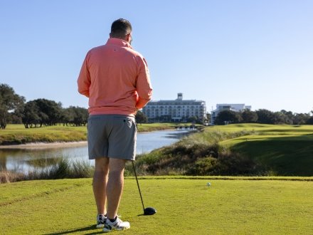 Golfer playing solo at Kiva Dunes coastal golf course in Fort Morgan