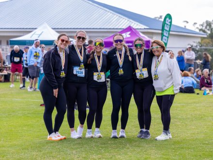 A group of friends after running the Coastal Half Marathon in Orange Beach, Alabama