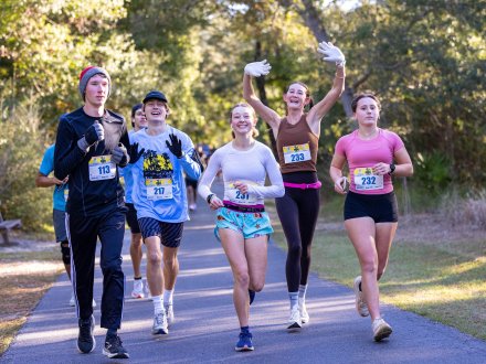 A group of friends running the Coastal Half Marathon on Alabama's Beaches