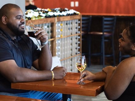 Couple sipping wine at Crush Wines at The Wharf