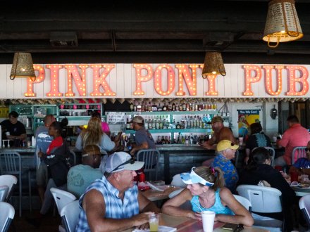 People dining inside the iconic Pink Pony Pub beachfront bar in Gulf Shores