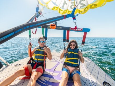 Friends parasailing on Alabama's Beaches