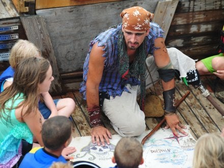 Kids reading a treasure map on the Orange Beach Pirate Ship Cruise.