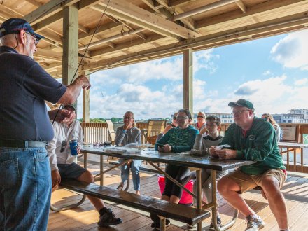 People attending the Gulf State Park Pier's Angler Academy fishing class