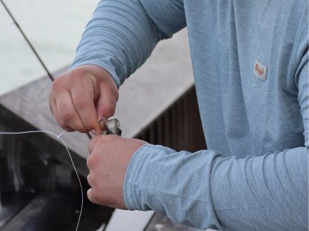 Angler baiting a hook at the Gulf State Park Fishing Pier in Gulf shores
