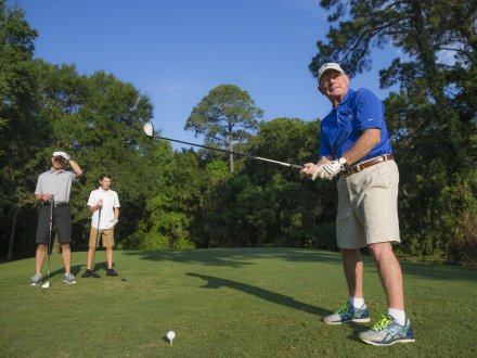 Family golfing together on Alabama's Beaches