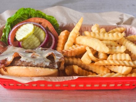 Burger and fries at Tiki & Raw Bar Orange Beach restaurant