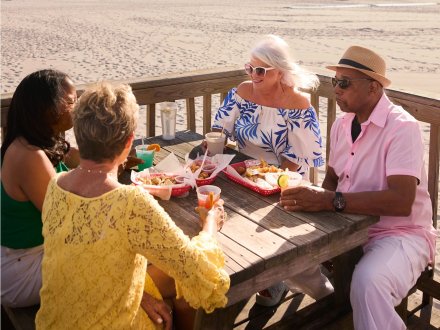 Snowbirds dining beachfront at Pink Pony Pub seafood restaurant in Gulf Shores