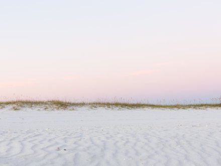 Scenic white sand beach in Gulf Shores at sunset