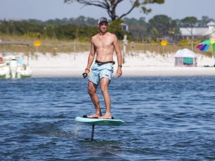 Man eFoil boarding in the bay, watersport in Orange Beach