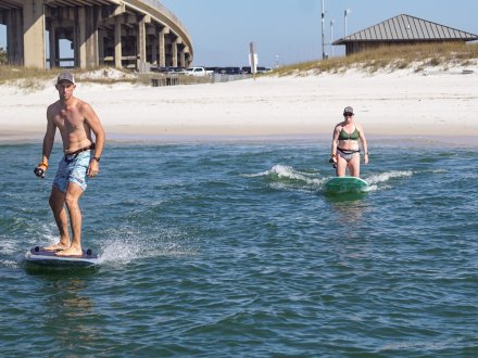 Adults taking an efoil boarding lesson in Orange Beach, fun water activity