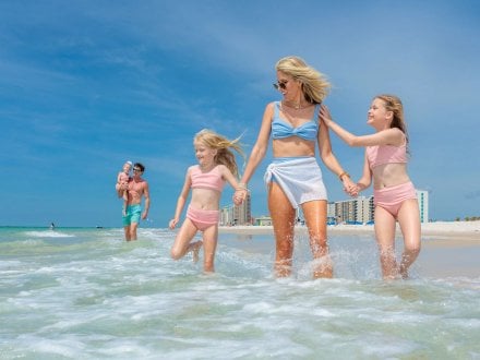 Family playing in the water on the beach in Gulf Shores