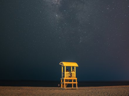 Stars shining above the shoreline on the beach in Gulf Shores