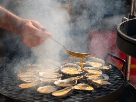 Oysters cooking on the grill at Experience the Oyster seafood festival in Gulf Shores