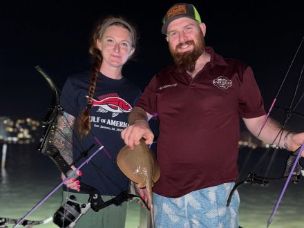 Anglers bow fishing on a night fishing charter in Orange Beach