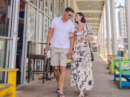 Couple walking at The Wharf, Orange Beach entertainment district