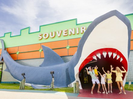 Family posing under the shark at Souvenir City store in Gulf Shores