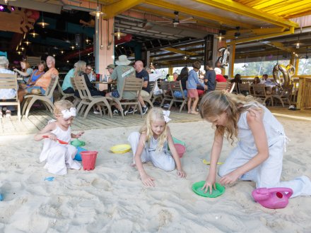 Girls playing the sandy area at LuLu's family friendly restaurant in Gulf Shores