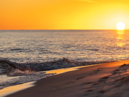 Vibrant orange sunset over the Gulf in Orange Beach