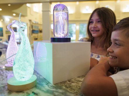 Children observing art at the Coastal Arts Center of Orange Beach