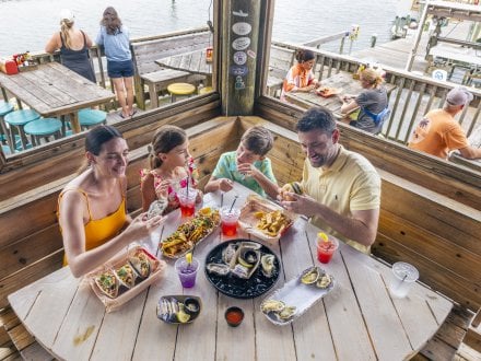 Family at Tiki & Raw Bar waterfront restaurant in Orange Beach