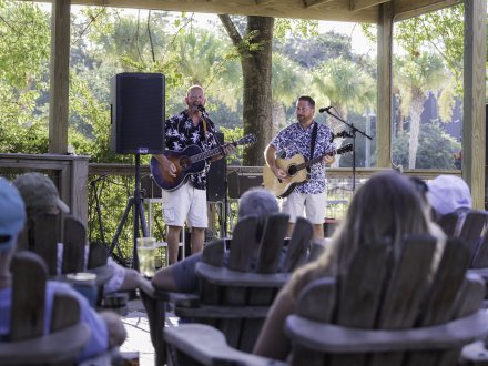 Guests watching live music on the outdoor patio at Big Beach Brewing in Gulf Shores