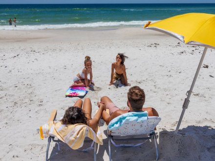 Family sitting on the beach in Gulf Shores