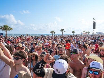 Crowd listening to performers at Sand in My Boots Fest