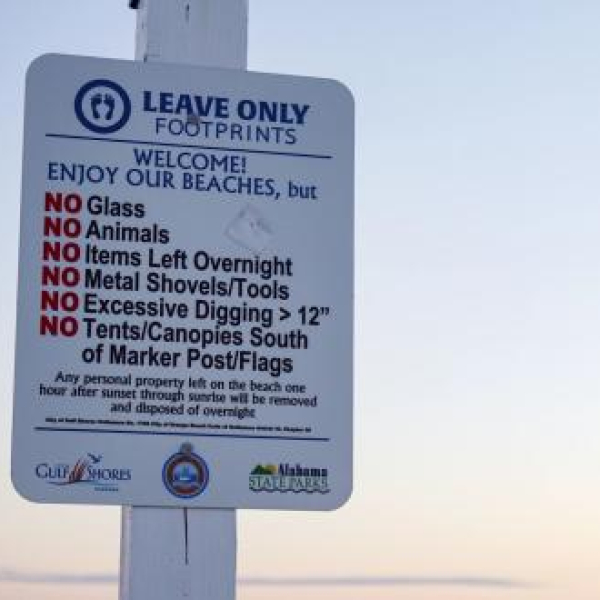Leave Only Footprints sign on the beach in Gulf Shores