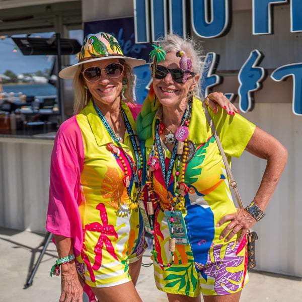 Two Meeting of the Minds attendees decked out in tropical attire
