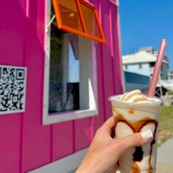 hand holding a peanut butter bushwacker at high tide daiquiris & mimosas 3 in gulf shores