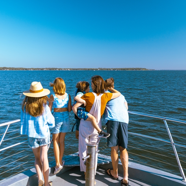Family looking out into the Gulf on a dolphin cruise in Orange Beach