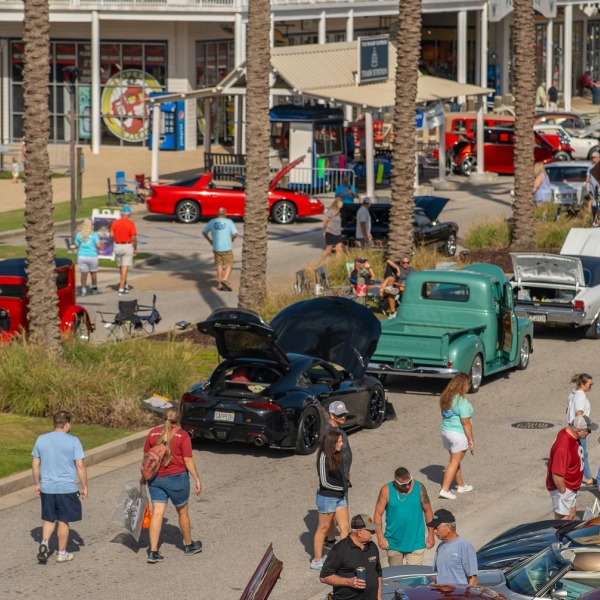 People admiring classic cars at the Bama Coast Cruisin' Fall Car Show at The Wharf