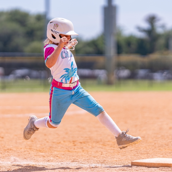 Player running to a base during a softball game on Alabama's Beaches