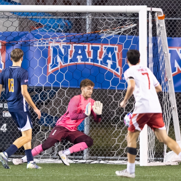 Goalie going to block a ball during a soccer game on Alabama's Beaches