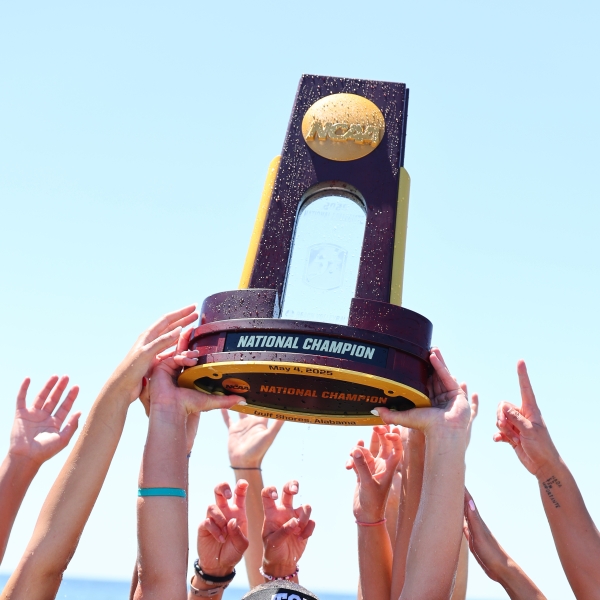 Winners of the NCAA Volleyball National Championship hoisting their trophy high on Alabama's Beaches