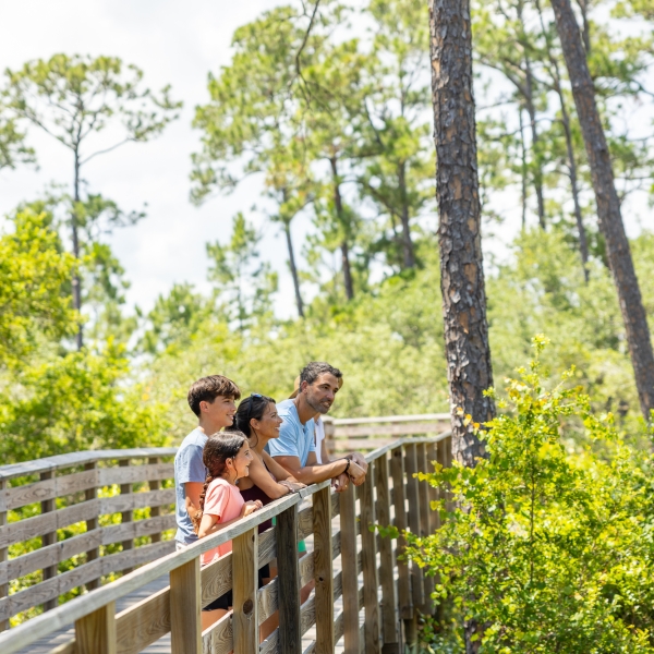 Family walking and enjoying the Gulf State Park together