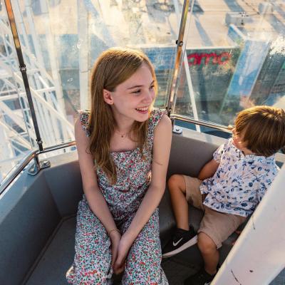 two kids riding the Ferris Wheel at the wharf