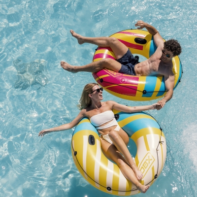 Couple on floats in the pool at their rental