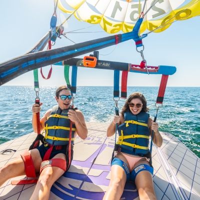 Couple parasailing during a spring trip on Alabama's Beaches