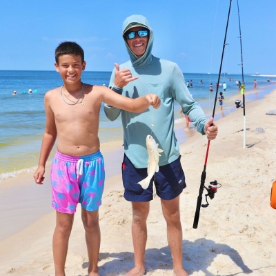 Kid learning to surf fishing during a summer camp on Alabama's Beaches