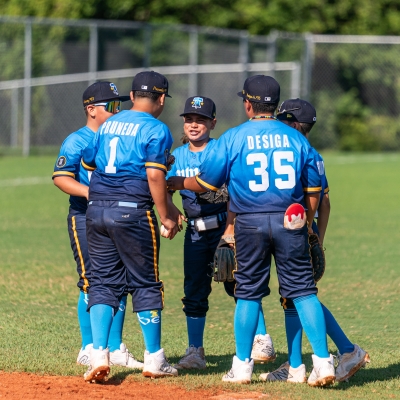Players huddling up while playing baseball on Alabama's Beaches
