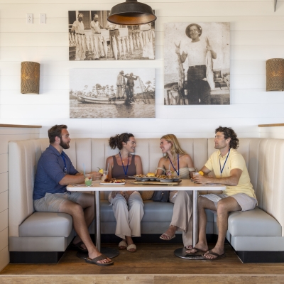 Attendees enjoying a meal at Coastal after a meeting