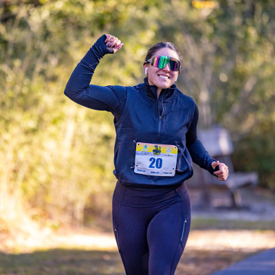 Girl running the Coastal Half Marathon