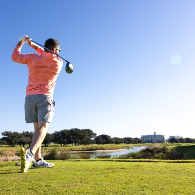 Man enjoying a round of golf on Alabama's Beaches