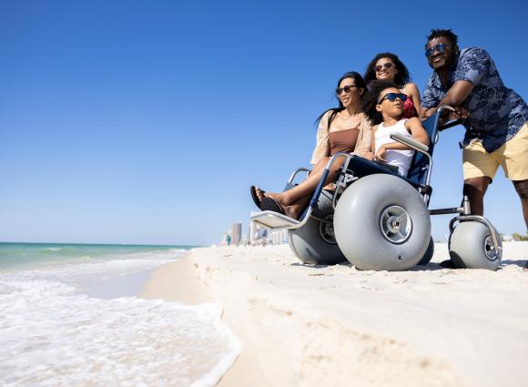 Family together near the shoreline at Gulf Place Public Beach in Gulf Shores