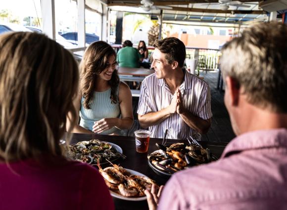 friends eating a meal at the gulf shores steamer seafood restaurant
